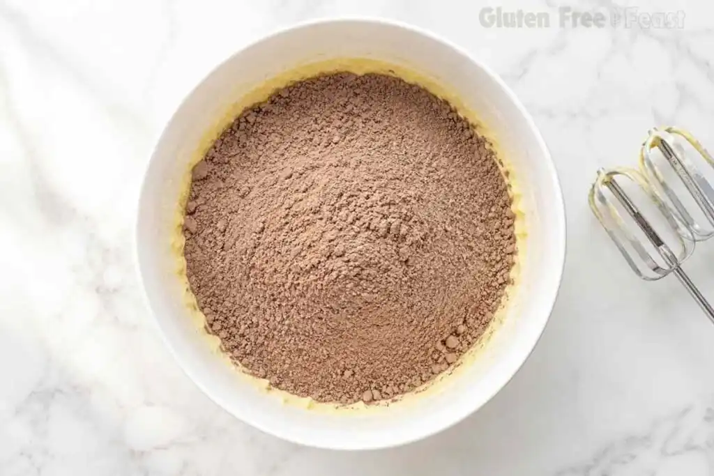 Dry chocolate cake ingredients added to the butter mixture
