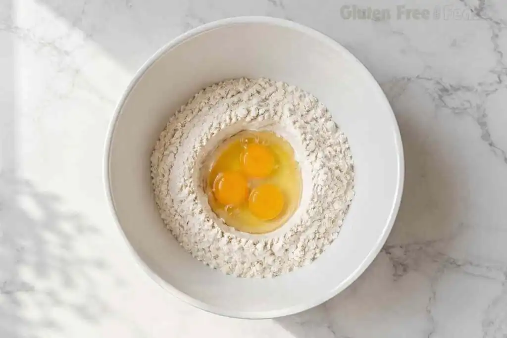 Eggs added to gluten-free flour for homemade pasta dough