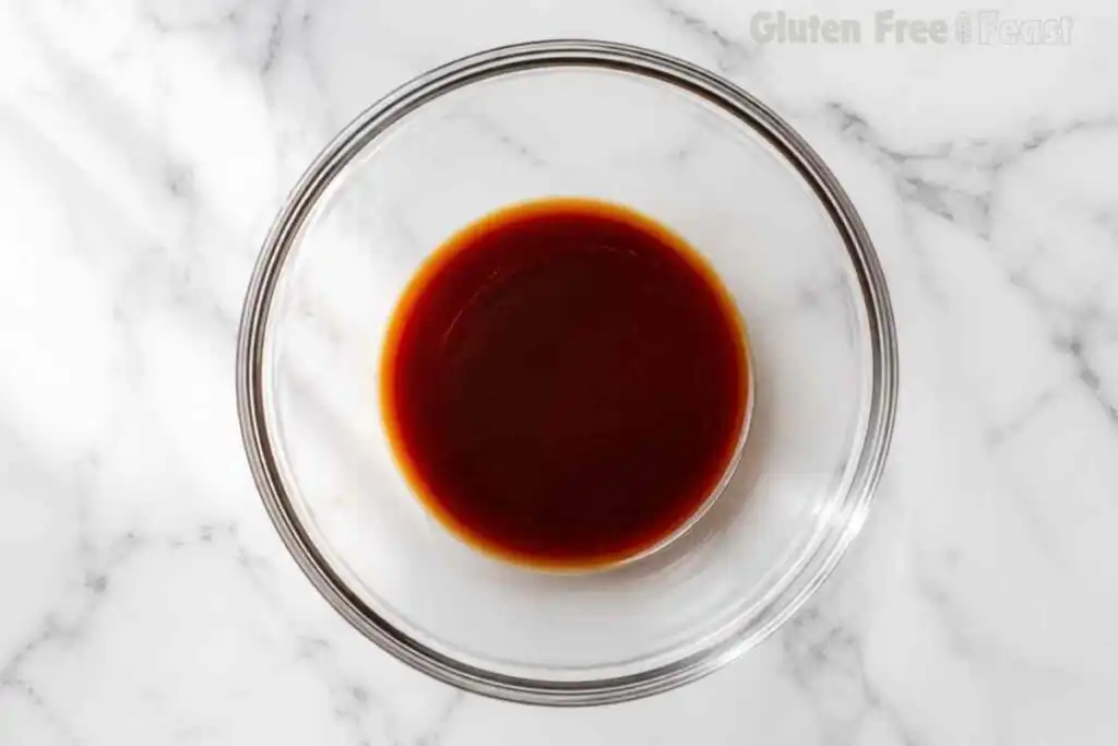 Pad thai sauce in a clear glass bowl on a marble surface