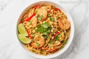 Shrimp cooking with bean sprouts and red peppers in a skillet for gluten free pad thai