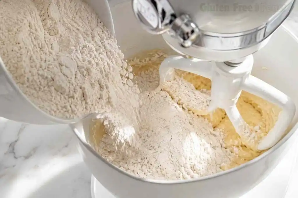 Pouring gluten free flour into stand mixer bowl for Christmas cookie dough Pouring gluten free flour into stand mixer bowl for Christmas cookie dough
