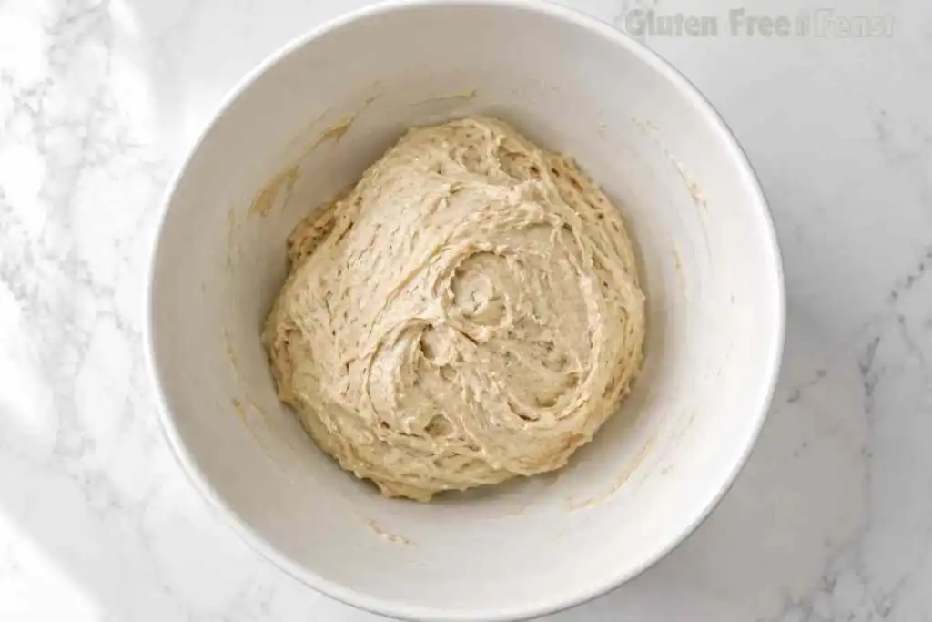 Chilled gluten free cinnamon roll dough in a white bowl