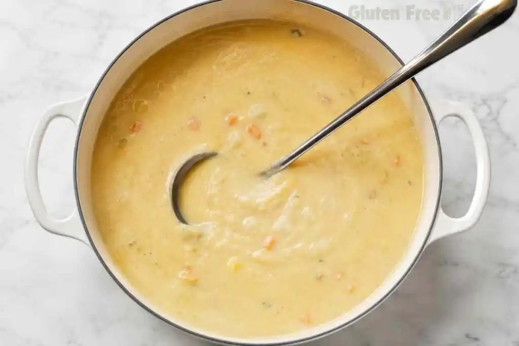Thick creamy potato soup finished in a white Dutch oven