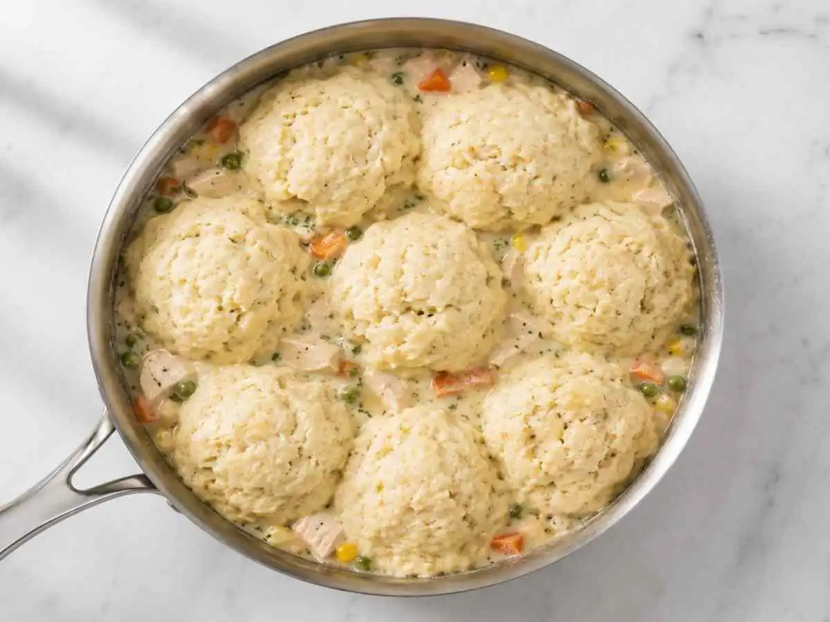 Overhead view of gluten free chicken and dumplings with fluffy steamed dumplings