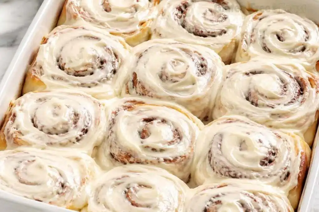 Gluten free cinnamon rolls topped with cream cheese frosting