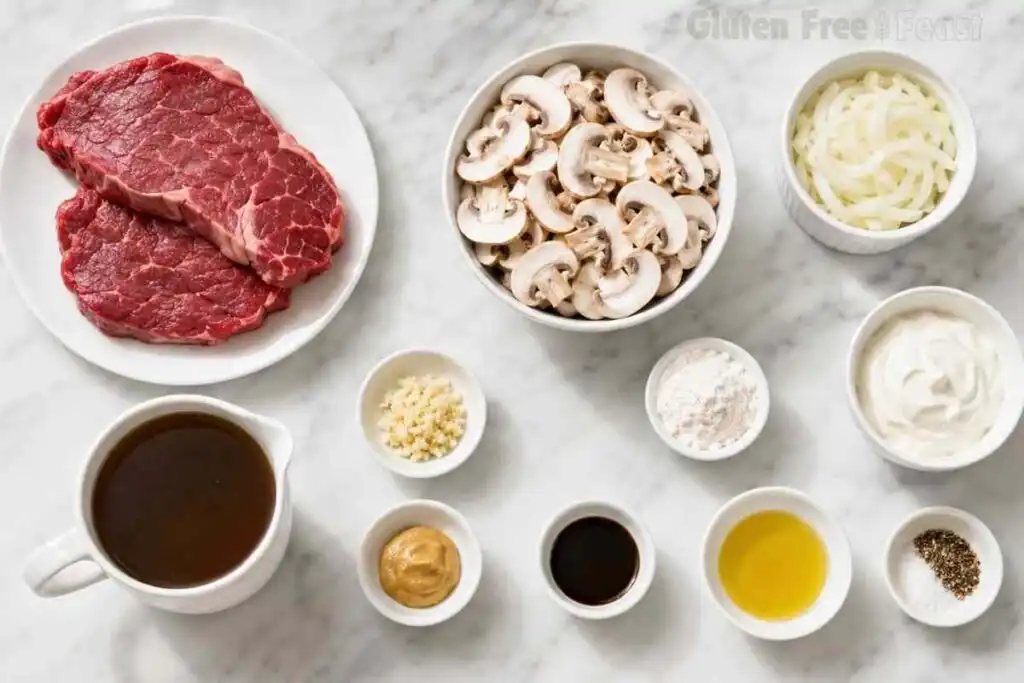 Ingredients for Gluten Free Beef Stroganoff including beef, mushrooms, onions, broth, sour cream, and gluten-free seasonings.